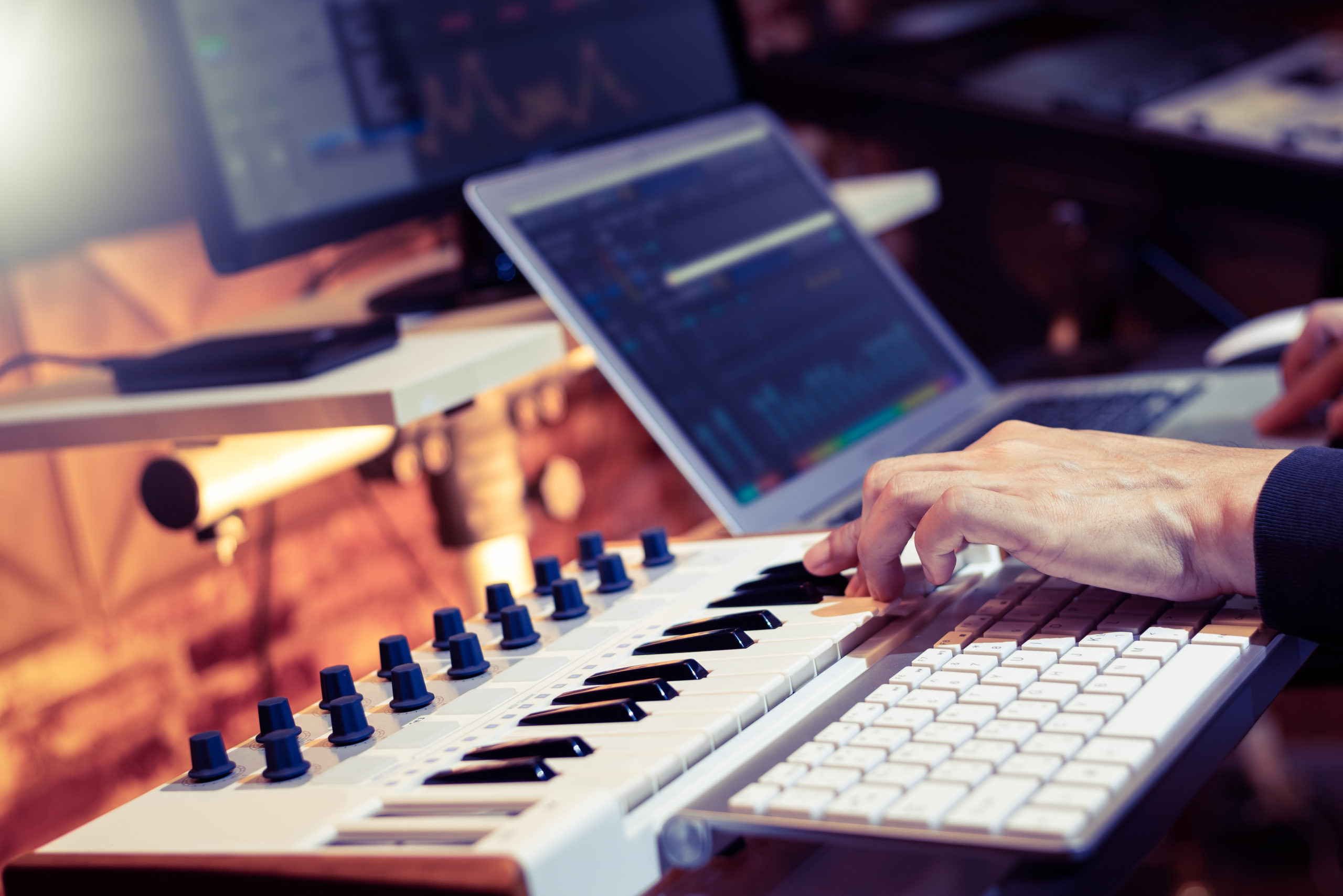 male producer, musician, composer making a song in home recording studio. music production concept