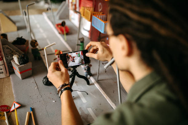 Stop motion artist filming a scene in his home office setup